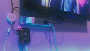 A rasberry pi and a USB audio capture device mounted next to a TV